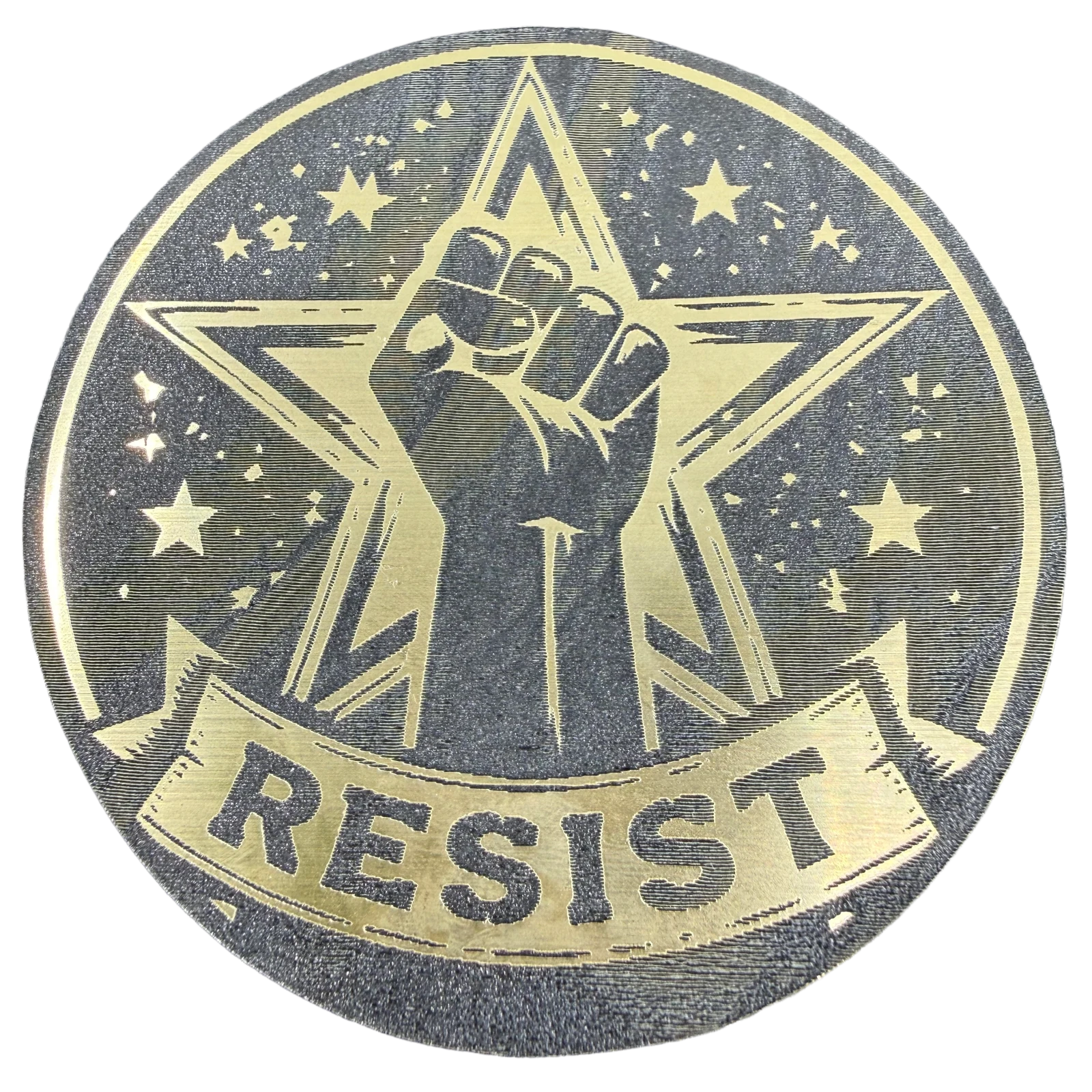 A gold-and-black RESIST emblem with a raised fist, star, and visible production texture.